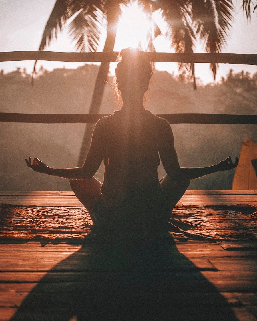 A woman seated quietly with eyes closed during a short breathing practice