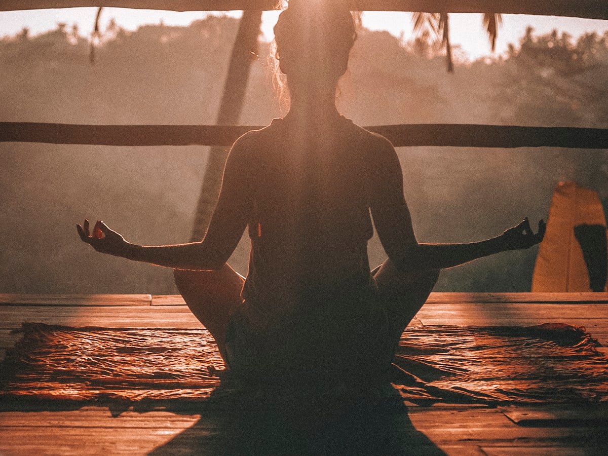 A woman seated quietly with eyes closed during a short breathing practice