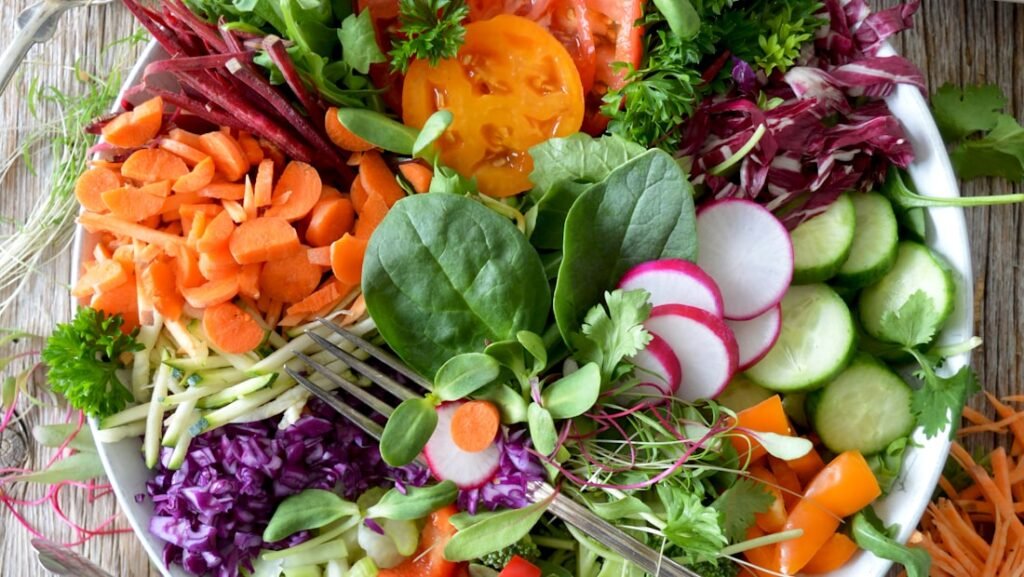 A bowl of leafy greens and chopped vegetables