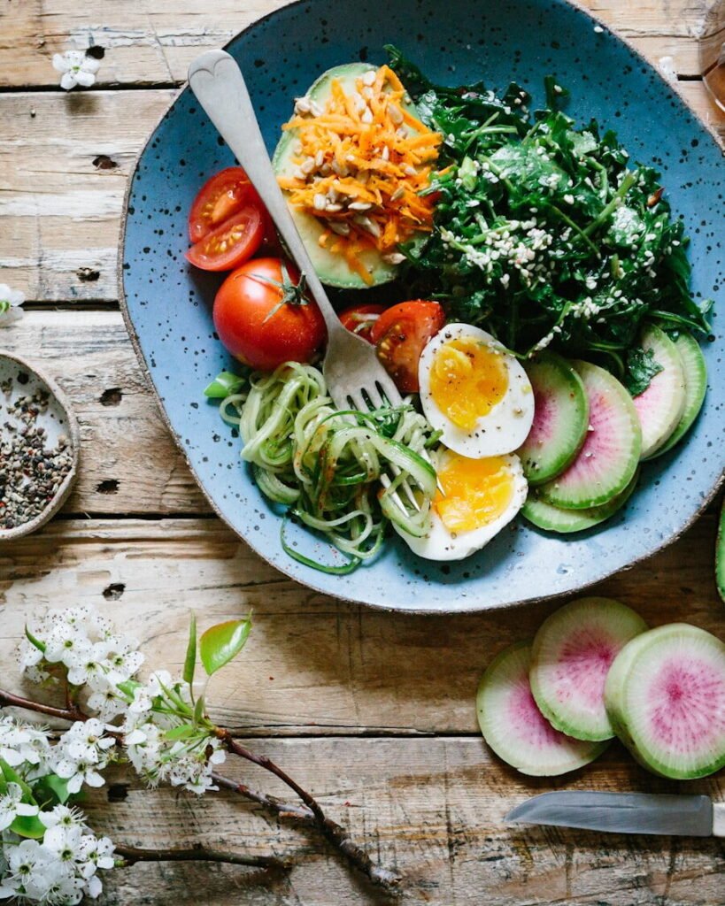 A balanced plate of salmon, leafy greens and whole grains photographed from above