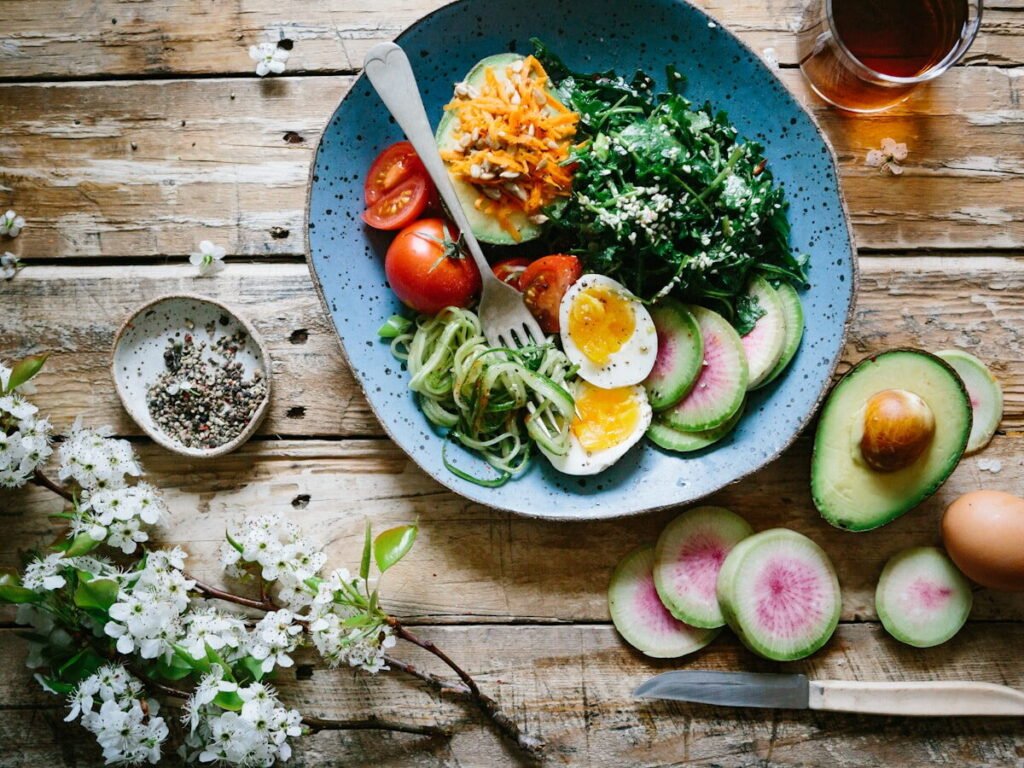 A balanced plate of salmon, leafy greens and whole grains photographed from above