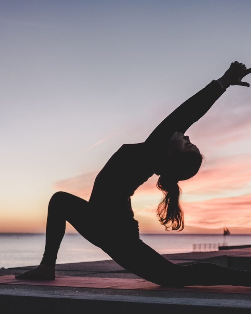 A woman stretching calmly in soft morning light during a gentle movement routine