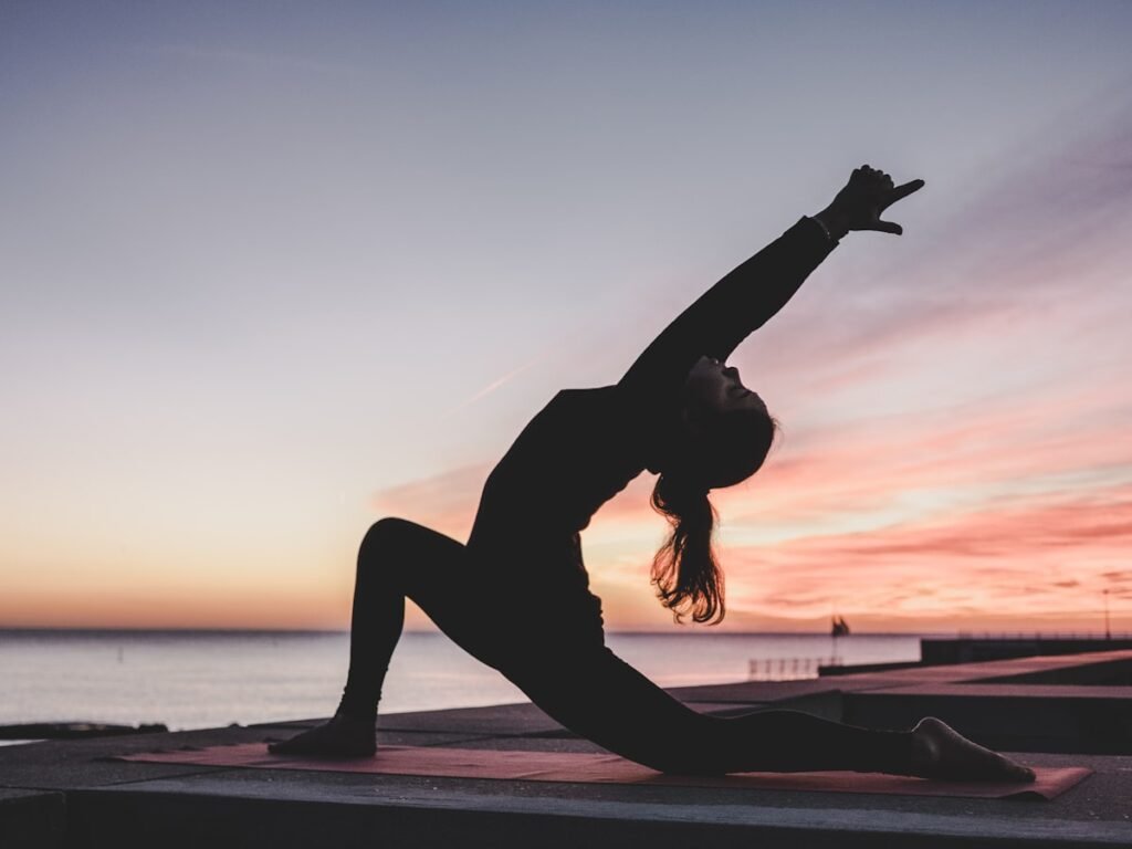 A woman stretching calmly in soft morning light during a gentle movement routine