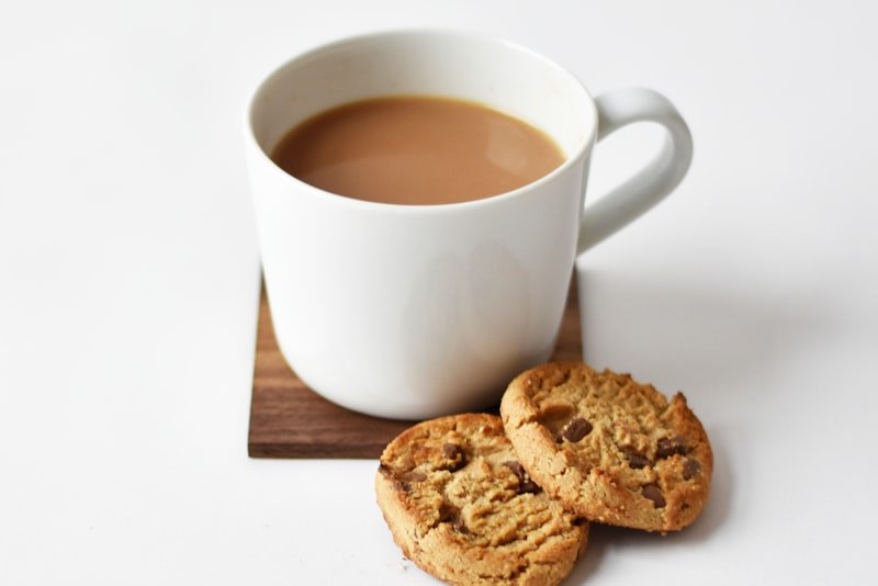 A glass cup of herbal tea steeping on a linen cloth
