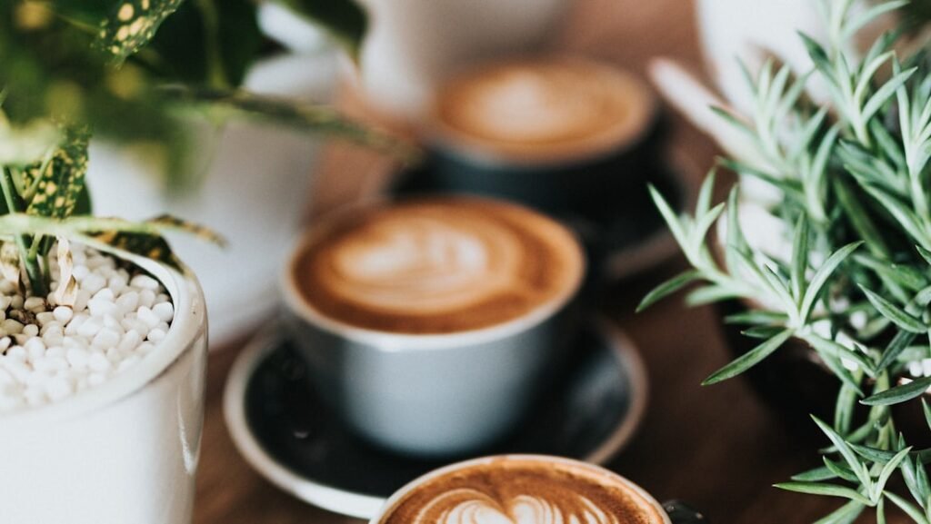 A cup of coffee on a wooden table in morning light