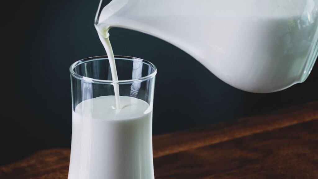 A glass of kefir beside fermented vegetables