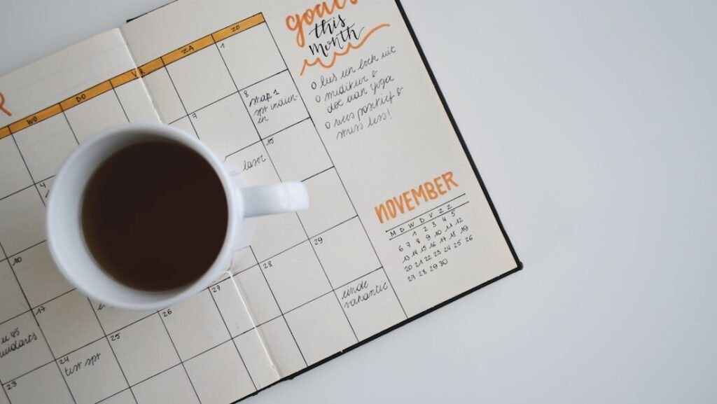 A notebook and pen used for recording symptoms across a menstrual cycle