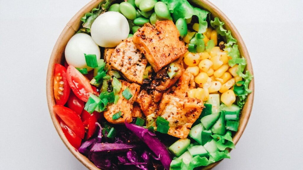 A large mixed salad bowl with vegetables and grains